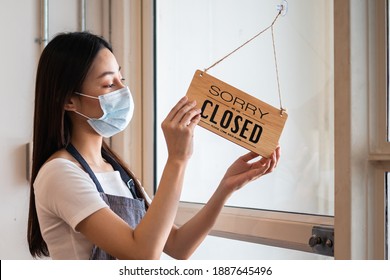 Young Asian Owner Retail,coffee Shop Woman Turning Sign Board To Closed With Wearing Face Mask,protection To Pandemic Of Coronavirus.Close Store,restaurant Or Pub Due To Lockdown, Quarantine Of Covid.