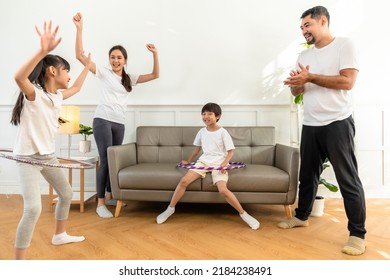 Young  Asian Parents With Child Meditating At Home Isolated In Room.  Family, Sport, Yoga Concept.