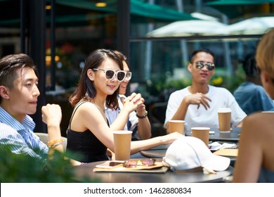 young asian people man and woman relaxing chatting in outdoor coffee shop