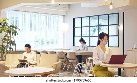 Young asian people working in the office. Co-working space. Social distancing.