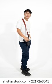 Young Asian Photographer Man Wearing A White T-shirt  Standing And Carry The Camera Over White Background