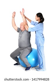 Young Asian Physiotherapist Working With Senior Man On White Background