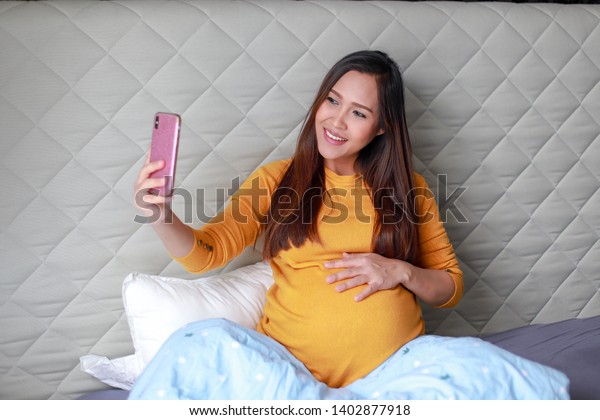 Young Asian Pregnant Woman Relaxing On Stock Photo Edit Now