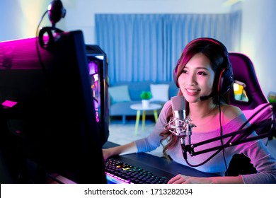 Young Asian Pretty Pro Gamer have live stream and chat with fans happily at home