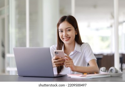 Young Asian Pretty Woman Using Laptop At Co Working Space.