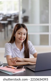 Young Asian Pretty Woman Using Laptop At Co Working Space.