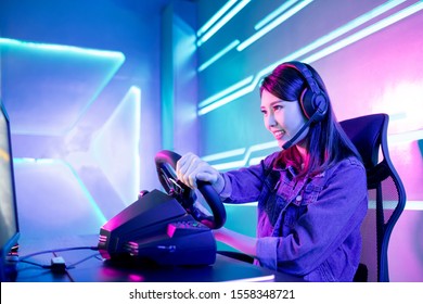 Young Asian Pro Gamer Girl Play Car Racing Online Video Game