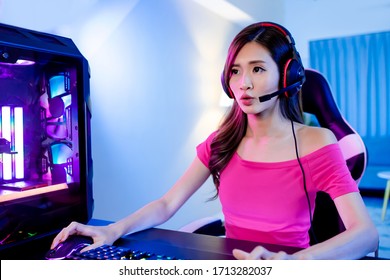 Young Asian Pro Gamer Girl Playing In Online Video Game With Rgb Keyboard And Mouse At Home