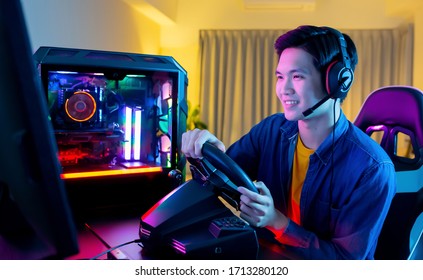 Young Asian Pro Gamer Man Play Car Racing Online Video Game