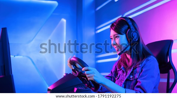 Young Asian Pro Gamer women Play Car Racing Online
Video Game