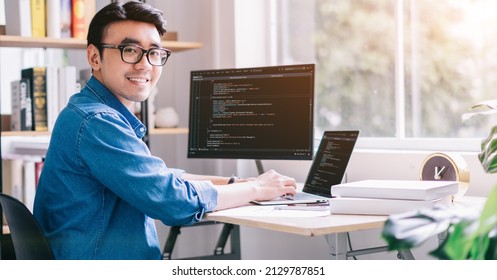 Young Asian programmer working at office - Shutterstock ID 2129787851