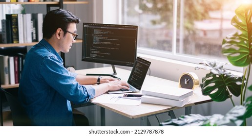 Young Asian programmer working at office - Shutterstock ID 2129787878