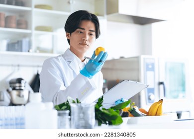 Young Asian researchers checking vegetables and fruits.