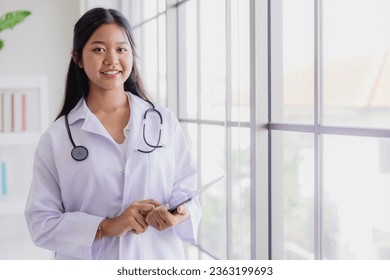 Young Asian roleplay as doctor standing happy smiling in school lab with space for text - Powered by Shutterstock