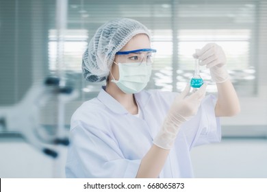 Young Asian Scientist With Test Tube Making Research In Clinical Laboratory.Science, Chemistry, Technology, Biology And People Concept