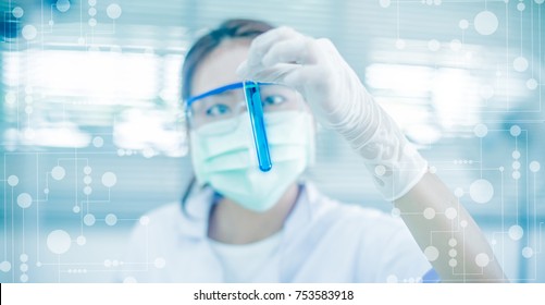 Young Asian scientist with test tube making research in clinical laboratory.Science, chemistry, technology, biology and people concept