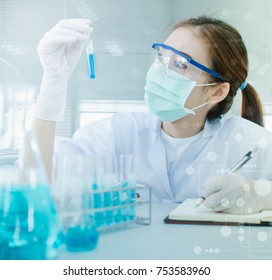 Young Asian scientist with test tube making research in clinical laboratory.Science, chemistry, technology, biology and people concept