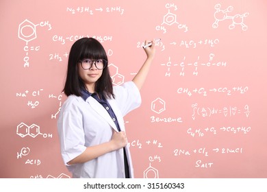 Young Asian Scientist Writing On Pink Wall