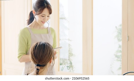 Young Asian Shop Clerk Working In The Cafe.