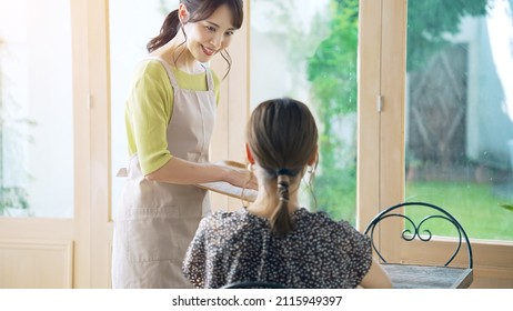 Young Asian Shop Clerk Working In The Cafe.