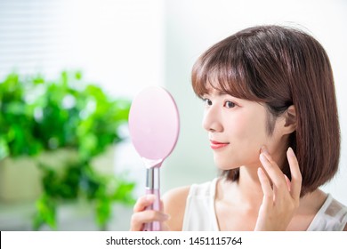 Young Asian Skin Care Woman Smile And Look Mirror