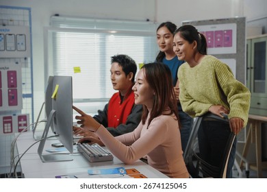 Young Asian software developers team working together on user interface design for mobile application using desktop computer in the office - Powered by Shutterstock - Get 15% off with code: PIKWIZARD15