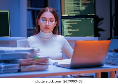 young Asian software development manager leads a late-night office discussion with his executive team, mentoring developers and analyzing source code to guide programming and project development