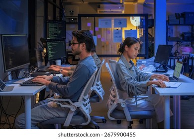 young Asian software development manager leads a late-night office discussion with his executive team, mentoring developers and analyzing source code to guide programming and project development