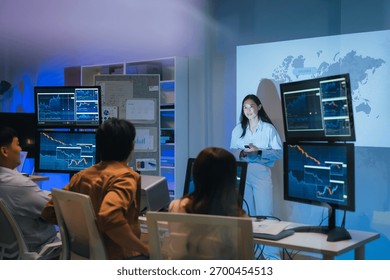 young Asian software development manager leads a late-night office discussion with his executive team, mentoring developers and analyzing source code to guide programming and project development	
