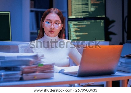 young Asian software development manager leads a late-night office discussion with his executive team, mentoring developers and analyzing source code to guide programming and project development