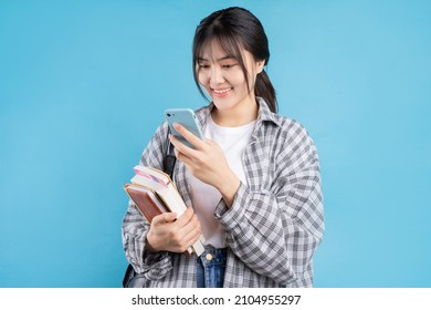 Young Asian Student On Blue Background