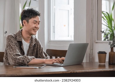 Young Asian student studying online, learning video on zoom call, teacher, happy young Asian boy learning English online with laptop computer. - Powered by Shutterstock