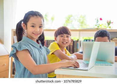 Young asian student using laptop computer in school library - Powered by Shutterstock