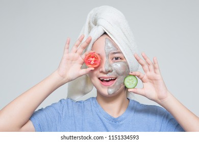 Young Asian Teenage Girl Hold Tomato And Cucumber, Smile Happy Face Masking Cream On Face And Towel On Head. Woman Beauty Shot With Idea Of Skin Care Nutrition. Suitable For Skin Care Cosmetic Product