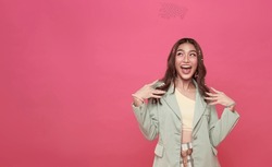 Young Asian Teenage Girl Surprised Excited Isolated On Pink Background.