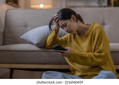 Young asian teenager woman feeling bored or Sad while playing smartphone at university, life concept