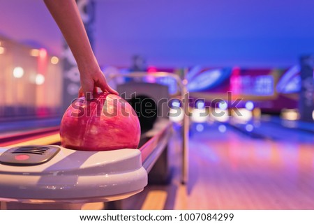 Young asian teennager holding bowling ball, bowling shoes and ball for bowling game, relaxing concept.