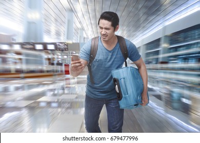 Young Asian Tourist Rushing To Boarding A Plane On The Departure Area