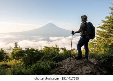 Young Asian tourist trekking to the top for seeing Mount Fuji in Japan summer season