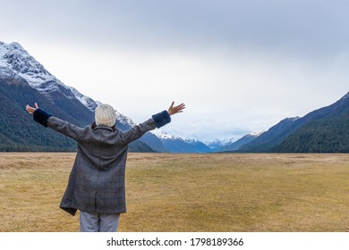 Young Asian Traveler Celebrating Success At Eglinton Valley, Te Anua, South Island, New Zealand