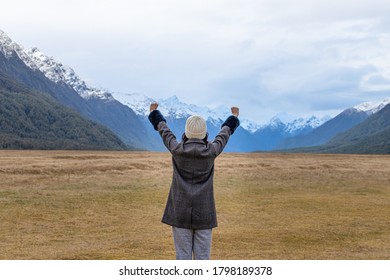 Young Asian Traveler Celebrating Success At Eglinton Valley, Te Anua, South Island, New Zealand