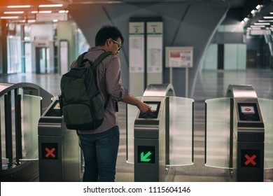 Young Asian Traveler Using Smart Card Pass The Door At Mass Rapid Transit (MRT) Train In Kuala Lumpur. MRT System Forming The Major Component Of The Railway System In Kuala Lumpur, Malaysia.