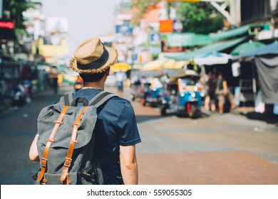 Young Asian traveling backpacker in Khaosan Road outdoor market in Bangkok, Thailand - Shutterstock ID 559055305
