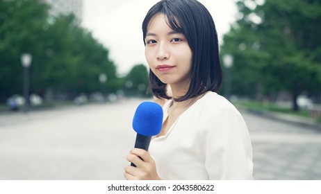 Young Asian TV Reporter In The Town.