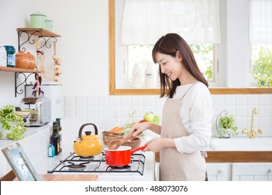 Young Asian Woman In The Kitchen?