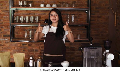 Young Asian Woman Barista Wear Apron OK Gesture