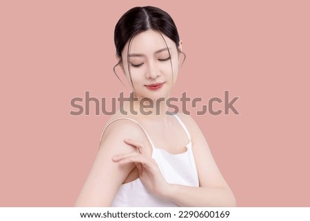 Young Asian woman with a beautiful face clean fresh smooth skin. Beauty female model with natural makeup isolated on pink background. 商業照片 © 
