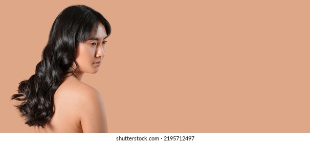 Young Asian Woman With Beautiful Long Wavy Hair On Beige Background With Space For Text