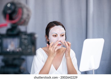 Young Asian woman beauty blogger or vlogger recording review product facial sheet mask for face skincare to share on social media.