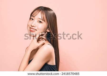 Young Asian woman blowing by wind her hair. Beauty, hair care and cosmetics concept. Stockfoto © 